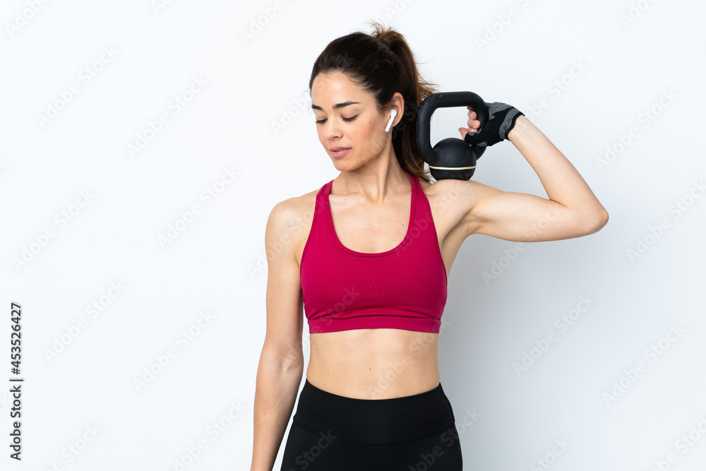 Sport woman over isolated white background making weightlifting with kettlebell Sport woman over isolated white background making weightlifting with kettlebell
