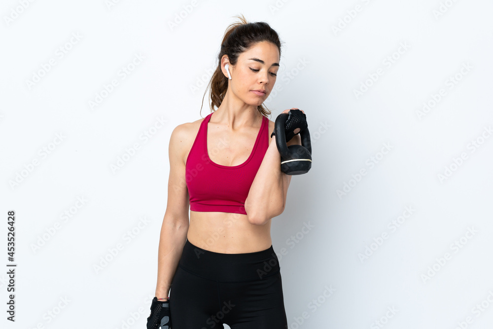 Sport woman over isolated white background making weightlifting with kettlebell Sport woman over isolated white background making weightlifting with kettlebell
