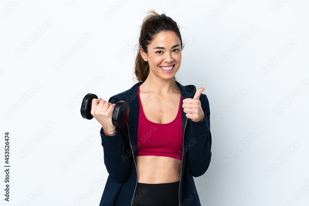 Sport woman making weightlifting over isolated white background with thumbs up because something good has happened Sport woman making weightlifting over isolated white background with thumbs up because something good has happened