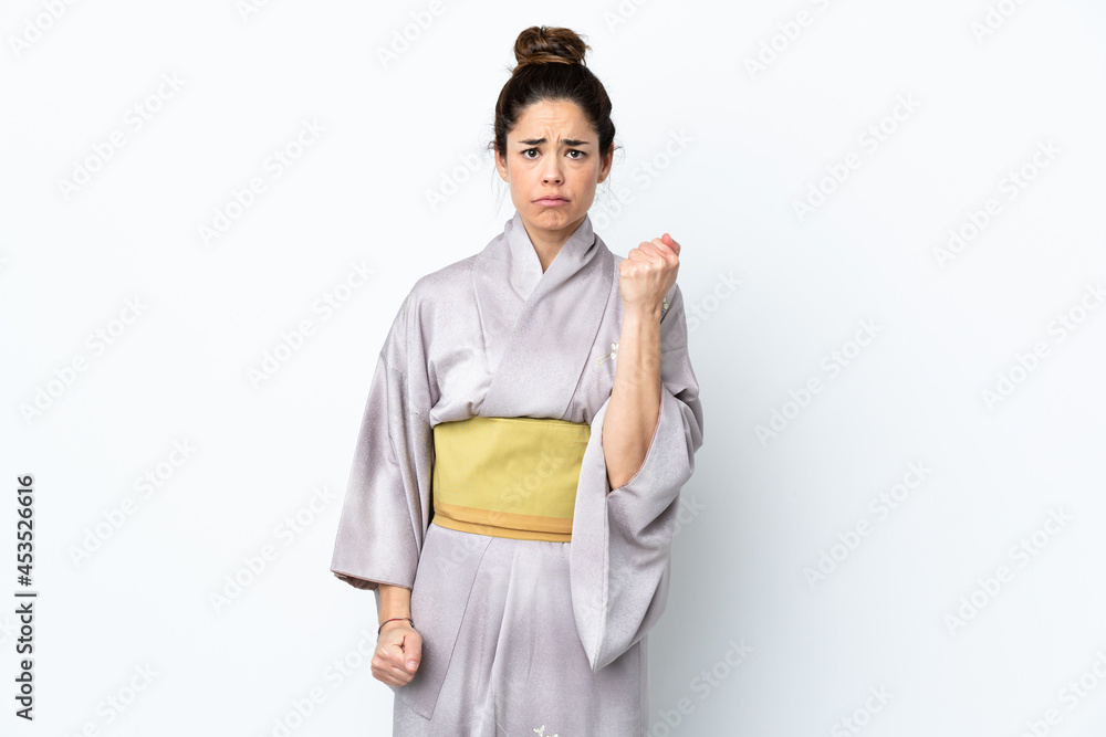 Woman wearing kimono over isolated background with unhappy expression Woman wearing kimono over isolated background with unhappy expression