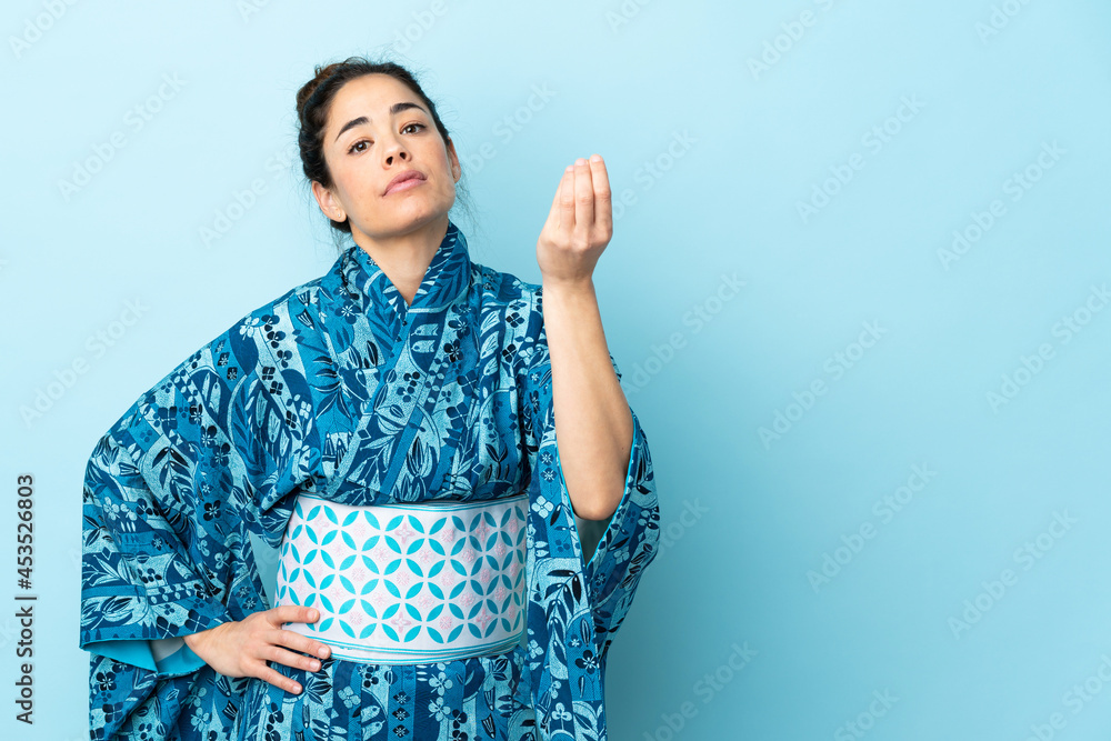 Woman wearing kimono over isolated background making Italian gesture Woman wearing kimono over isolated background making Italian gesture