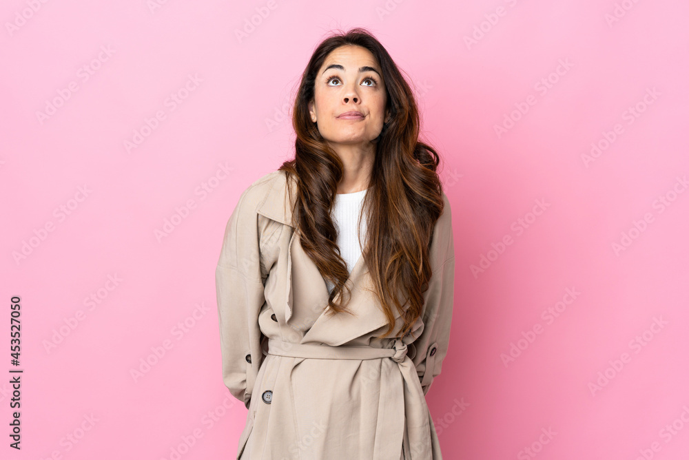 Woman over isolated background and looking up Woman over isolated background and looking up