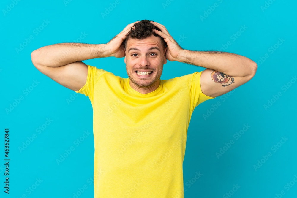 Young caucasian handsome man isolated on blue background doing nervous gesture Young caucasian handsome man isolated on blue background doing nervous gesture