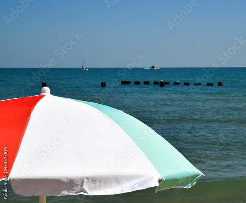 colorful beach umbrella in summer © BradleyWarren