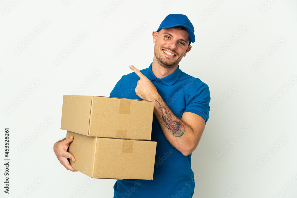 Delivery caucasian man isolated on white background pointing to the side to present a product Delivery caucasian man isolated on white background pointing to the side to present a product