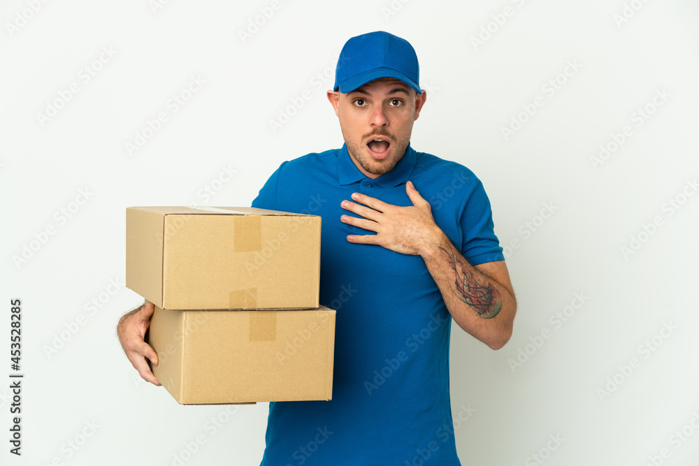 Delivery caucasian man isolated on white background surprised and shocked while looking right Delivery caucasian man isolated on white background surprised and shocked while looking right