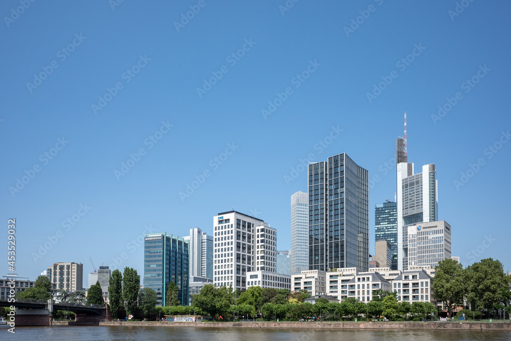 Outdoor sunny view of cityscape and promenade of riverside Main river in Frankfurt, Germany during sunny day. Outdoor sunny view of cityscape and promenade of riverside Main river in Frankfurt, Germany during sunny day.