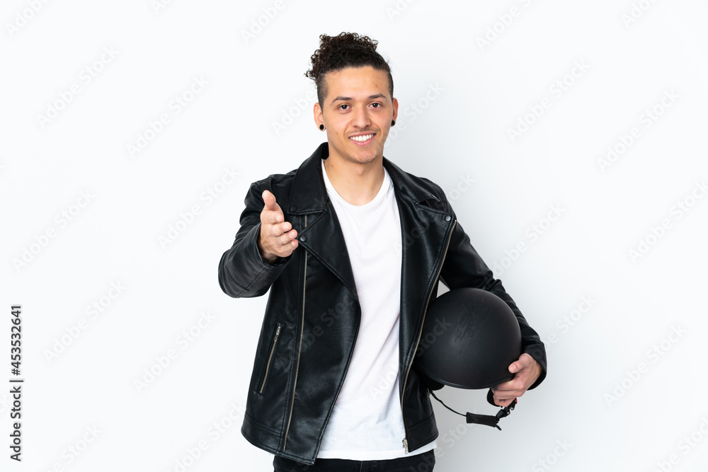 Caucasian man with a motorcycle helmet over isolated white background handshaking after good deal Caucasian man with a motorcycle helmet over isolated white background handshaking after good deal