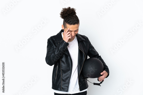 Caucasian man with a motorcycle helmet over isolated white background laughing