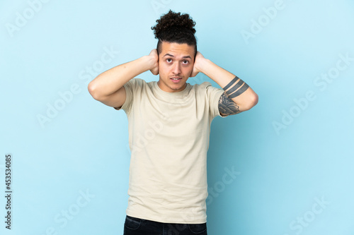 Caucasian man over isolated background frustrated and covering ears