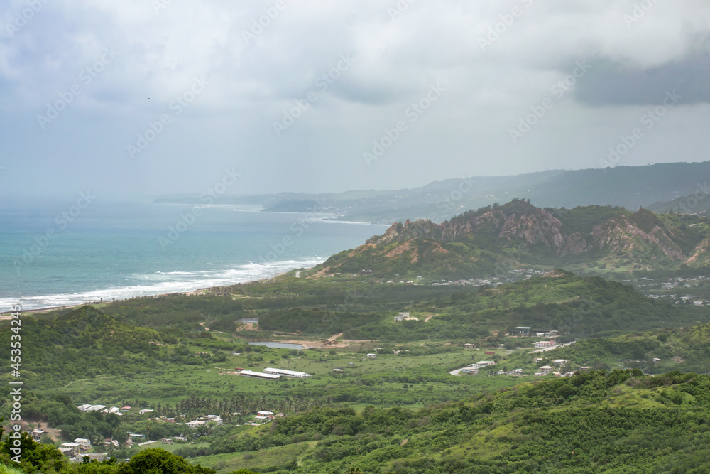 A view from Cherry Tree Hill in Barbados. Trees, hills and the coast with the ocean can be seen. A view from Cherry Tree Hill in Barbados. Trees, hills and the coast with the ocean can be seen.