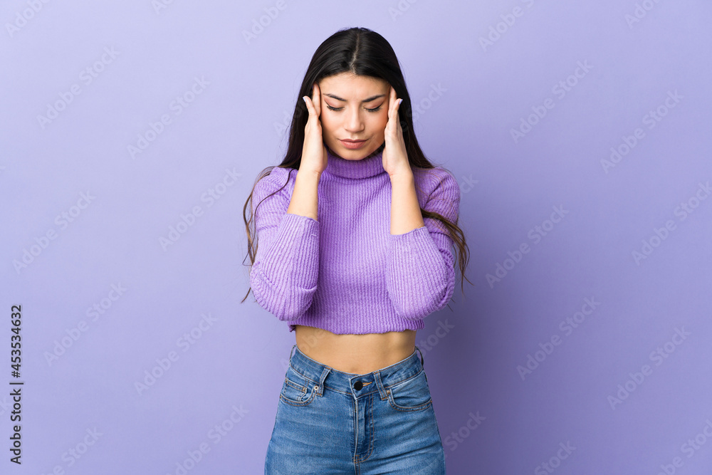 Young brunette woman over isolated purple background with headache Young brunette woman over isolated purple background with headache