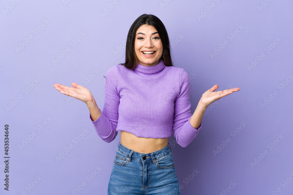 Young brunette woman over isolated purple background with shocked facial expression Young brunette woman over isolated purple background with shocked facial expression