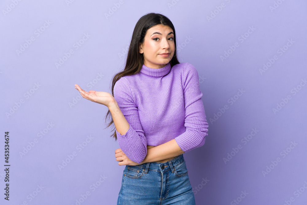 Young brunette woman over isolated purple background having doubts Young brunette woman over isolated purple background having doubts