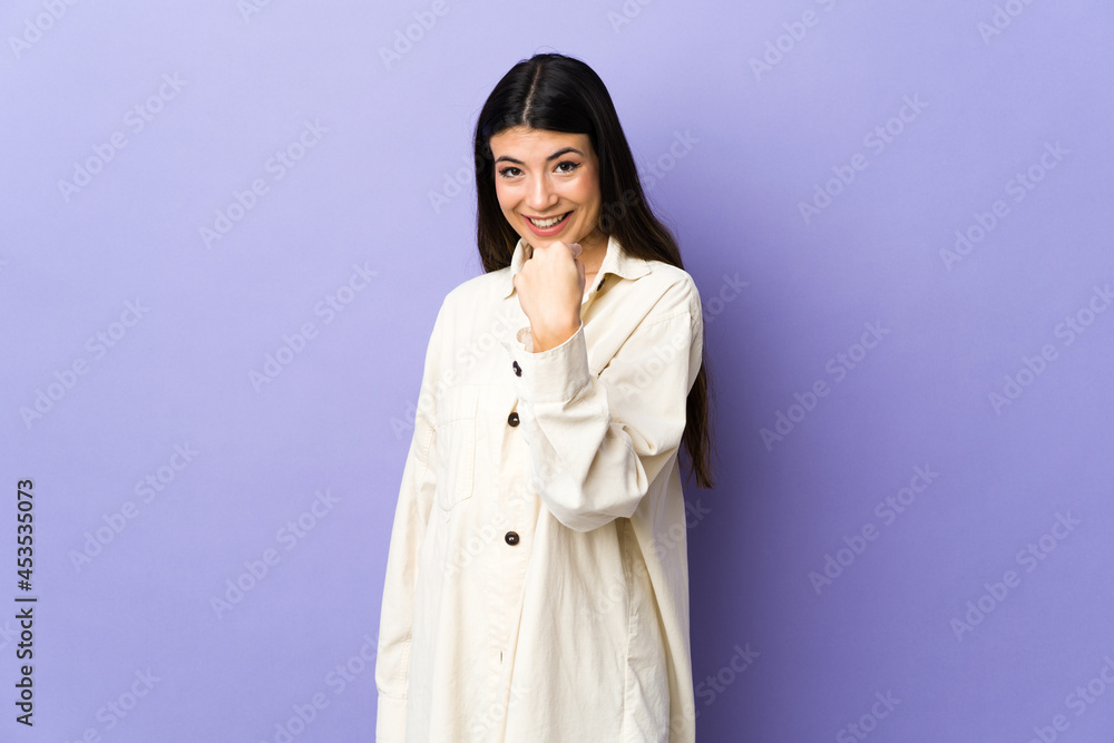 Young brunette woman over isolated purple background doing coming gesture Young brunette woman over isolated purple background doing coming gesture