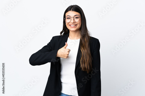 Business woman over isolated white background giving a thumbs up gesture