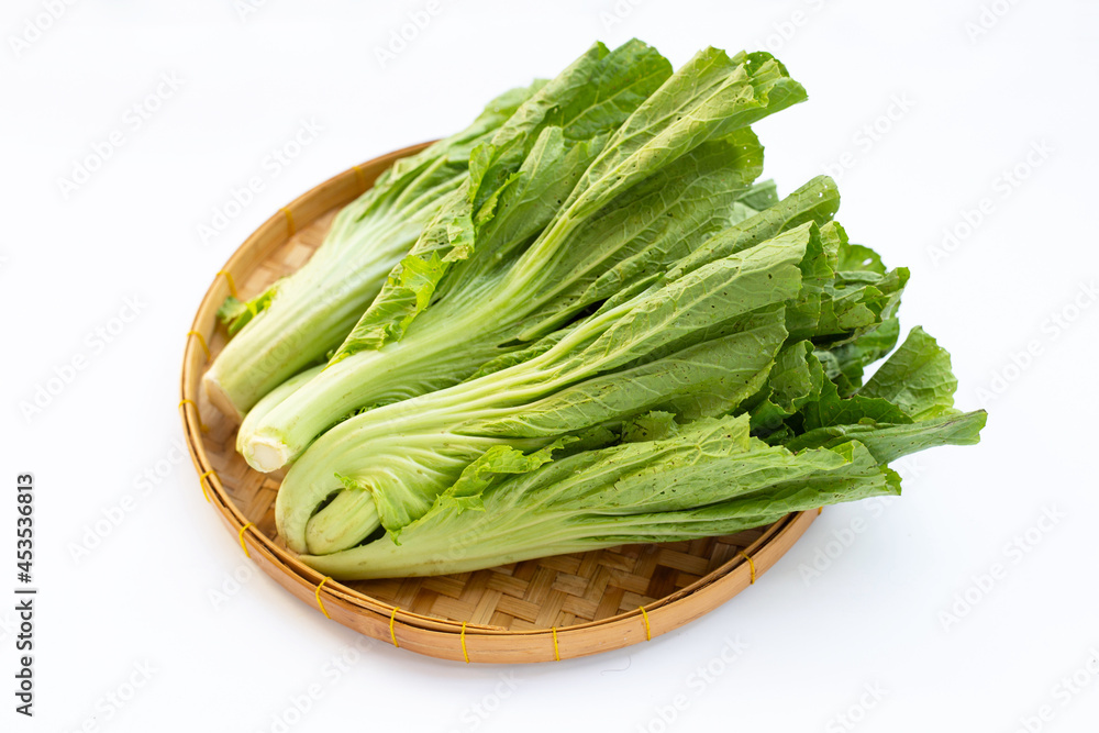 Mustard Green in bamboo basket on white background. Mustard Green in bamboo basket on white background.