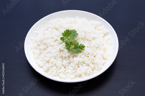 Dish of rice on dark background.