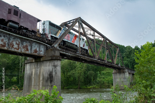 Train crossing Warren through truss bridge over Tuckasegee River on Great Smoky Mountains Railroad, Swain County, North Carolina