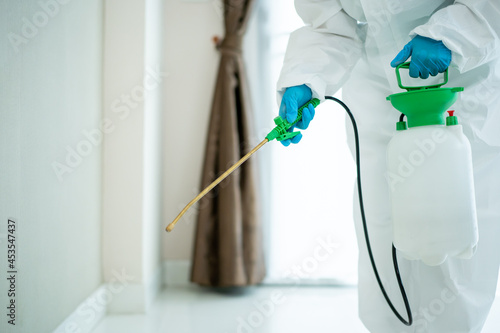 Photos Sanitary staff sanitizing a surface inside the building cause coronavirus or COVID-19 disease pandemic