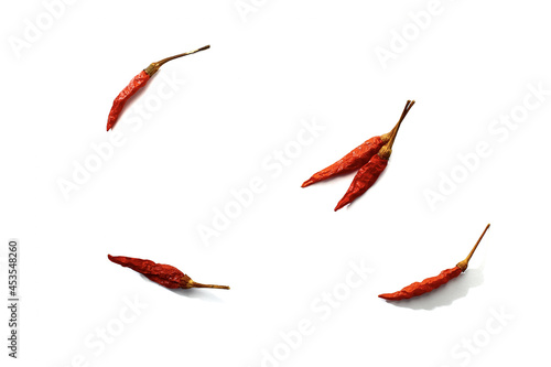 Dry red hot chili peppers on white background