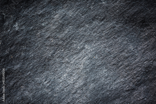 Patterned structure of black slate background texture for design.