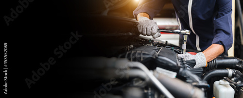 Automobile mechanic repairman hands repairing a car engine automotive workshop with a wrench, car service and maintenance,Repair service.