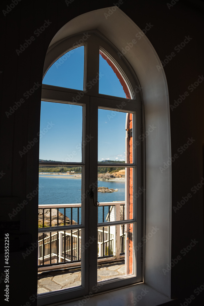 Sea view through the lighthouse arched window.