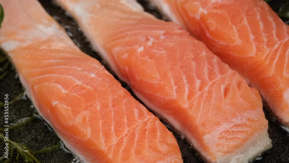 Frying salmon fish fillet close up. Cooking fish on pan. Sliding shot. 4K UHD video Frying salmon fish fillet close up. Cooking fish on pan. Sliding shot. 4K UHD video