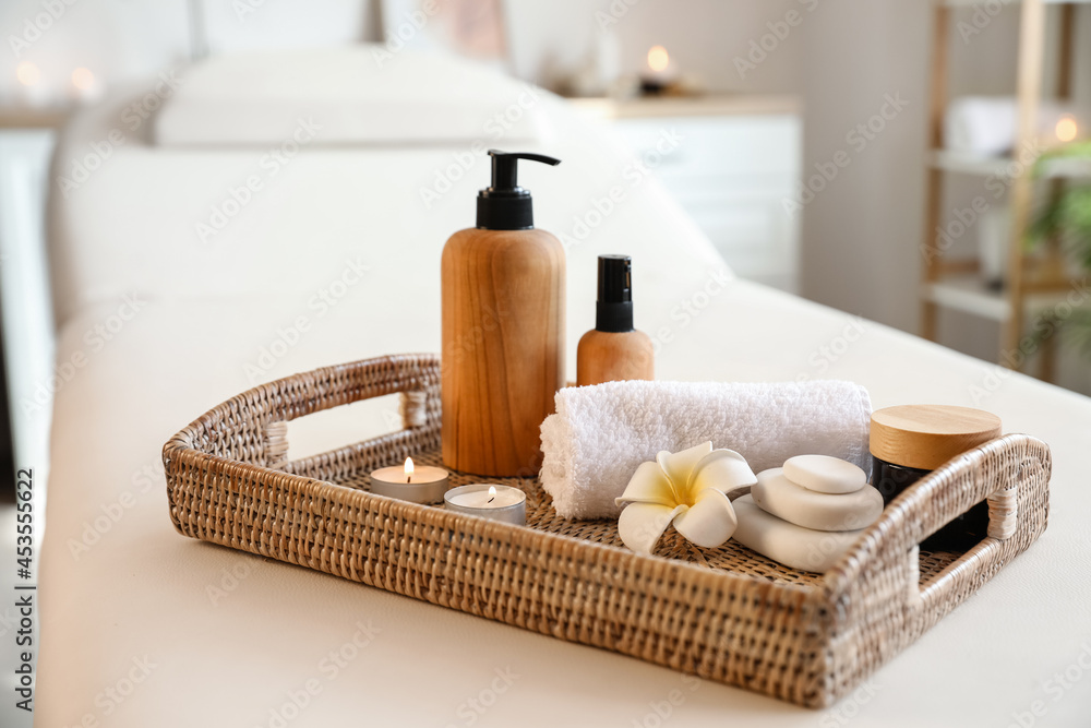 Tray with beautiful spa composition on couch in salon Tray with beautiful spa composition on couch in salon