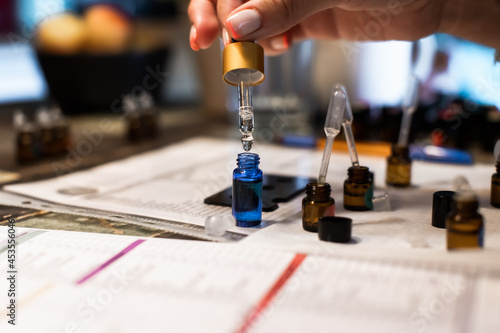 Tableau sur toile Dilution of oil with a pipette with a bottle