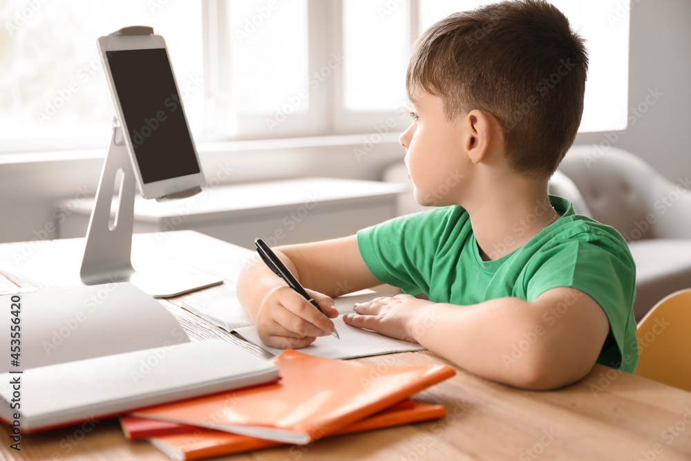 Little boy studying online at home Little boy studying online at home