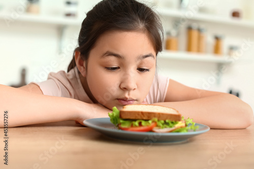 Little girl with tasty sand...