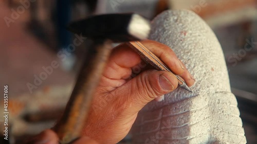Stone carving master. Creative workshop with artwork.