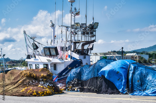 Zona portuaria y barco pesquero amarrado en el puerto de Santoña en Cantabria, España photo