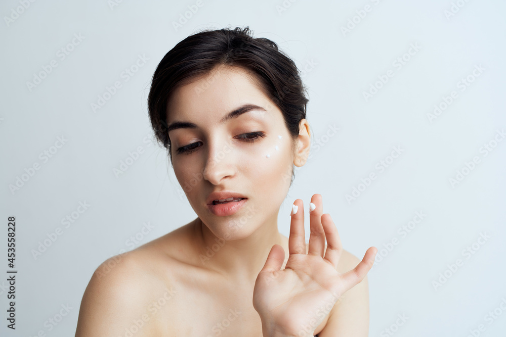 pretty brunette with bare shoulders face skin care health light background pretty brunette with bare shoulders face skin care health light background