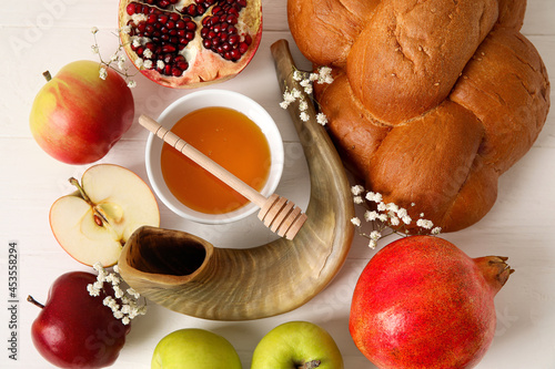 Symbols of Rosh hashanah (Jewish New Year) on white wooden background photo