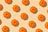 Top view closeup photo of orange pumpkins on isolated beige background