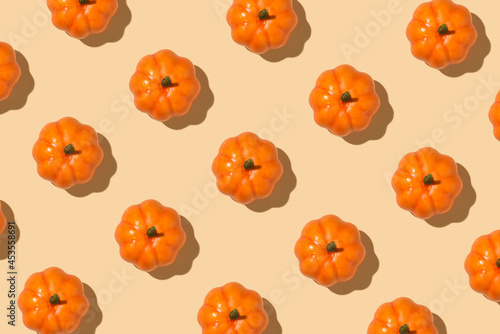 Top view closeup photo of orange pumpkins on isolated beige background