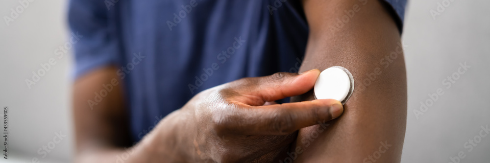 Fototapeta premium Man Testing Glucose Level With A Continuous Glucose Monitor