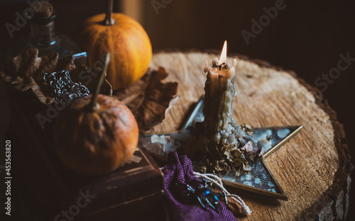 Candle burns on the altar, magic among candles, clean energy, magical concept, autumn time	 photo