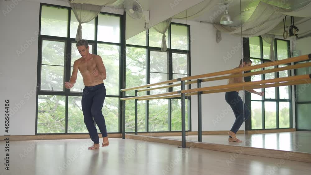 4K Confidence Caucasian male ballet dancer practicing ballet dance alone in studio room. Handsome man athletic dancing classic ballet showing performance body stretching and strength muscle. 4K Confidence Caucasian male ballet dancer practicing ballet dance alone in studio room. Handsome man athletic dancing classic ballet showing performance body stretching and strength muscle.