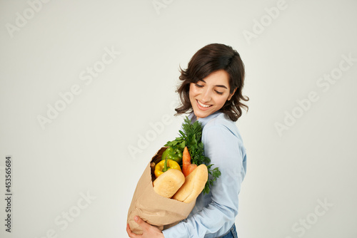 pretty woman food bag vegetables healthy food light background