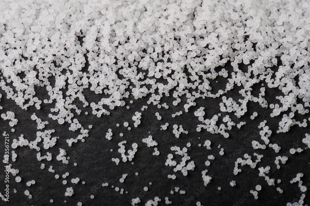 White pvs granules on black background White pvs granules on black background