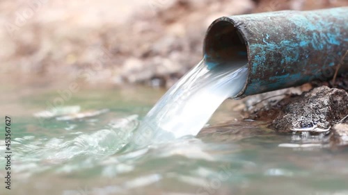 sewage from the sewer pollutes a lake, top view, slow motion