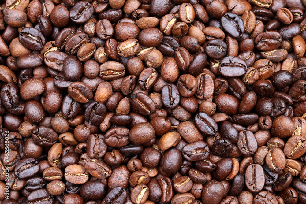 Fototapeta premium Roasted coffee beans background. Beverage concept for wallpaper, backdrop and texture.