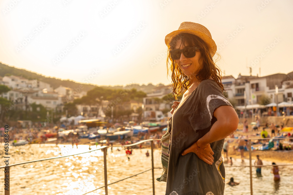 A young tourist at sunset on the coast of Tamariu in the town of Palafrugell. Girona, Costa Brava in the Mediterranean