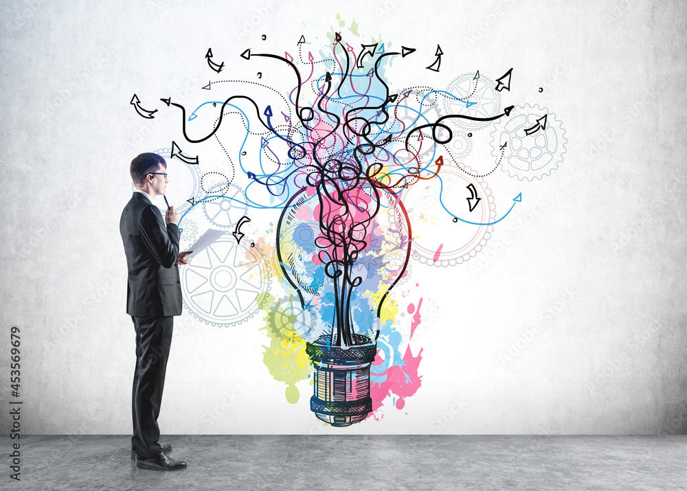 Businessman in formal suit is looking at colourful sketch