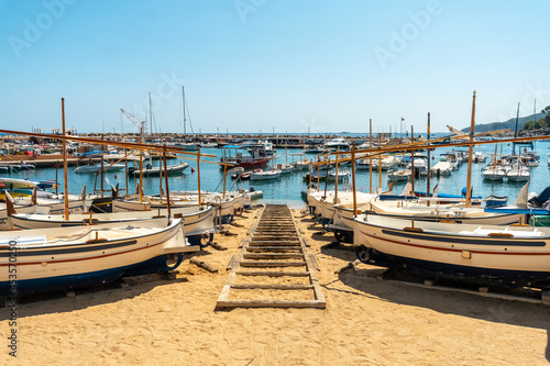 Canvas Print Beach full of boats in Llafranc, Girona on the Costa Brava of Catalonia in the M
