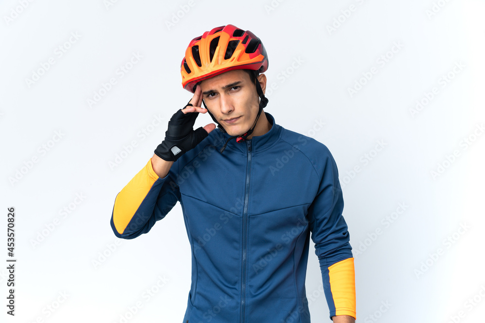 Young cyclist man isolated on background thinking an idea Young cyclist man isolated on background thinking an idea